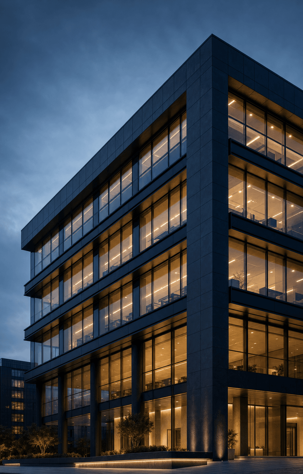 Contemporary London commercial building with warm interior lighting at blue hour